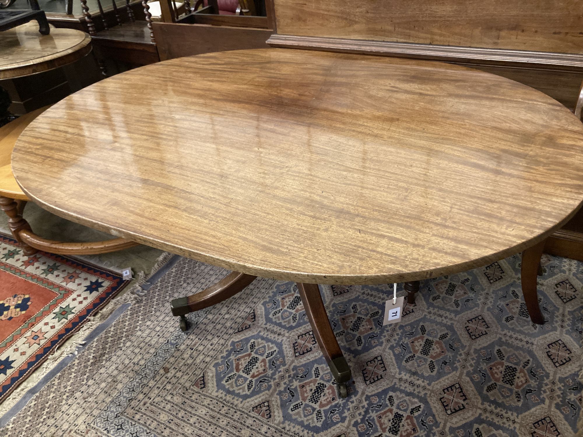 A George III oval mahogany tilt top dining table, width 158cm depth 120cm height 74cm